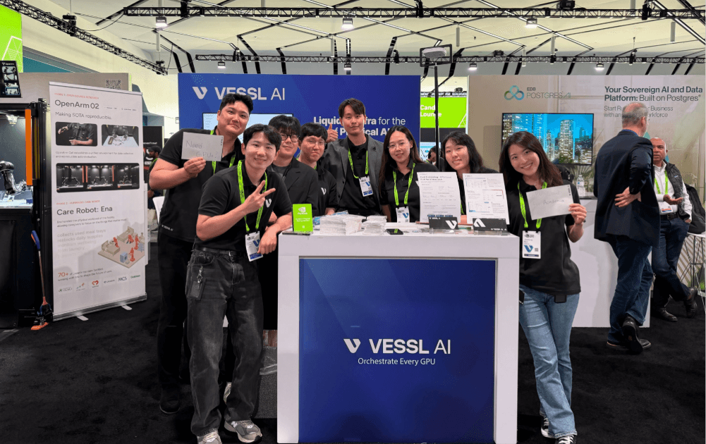 GTC 2026 VESSL AI 부스에서 팀원들이 함께 포즈를 취하고 있다. 뒤편에 VESSL AI 로고와 Orchestrate Every GPU 슬로건이 보인다.